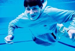 swimming in blue hoodie underwater