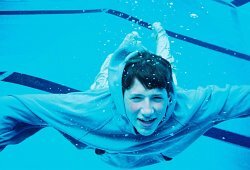 swimming in blue hoodie underwater